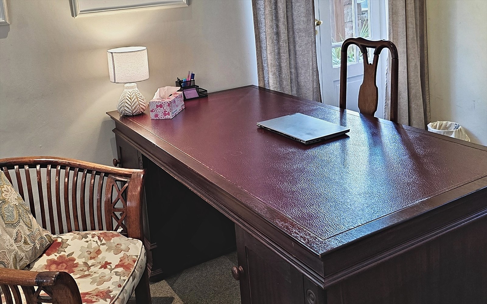 Mahonie bureau met leeslamp en anatomische prenten aan de wand